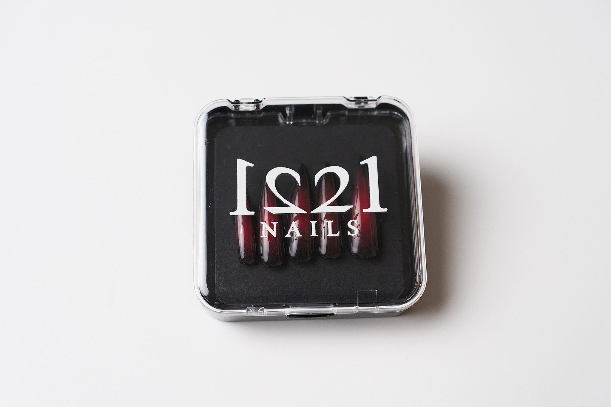 Black and Red Aura nails in their case