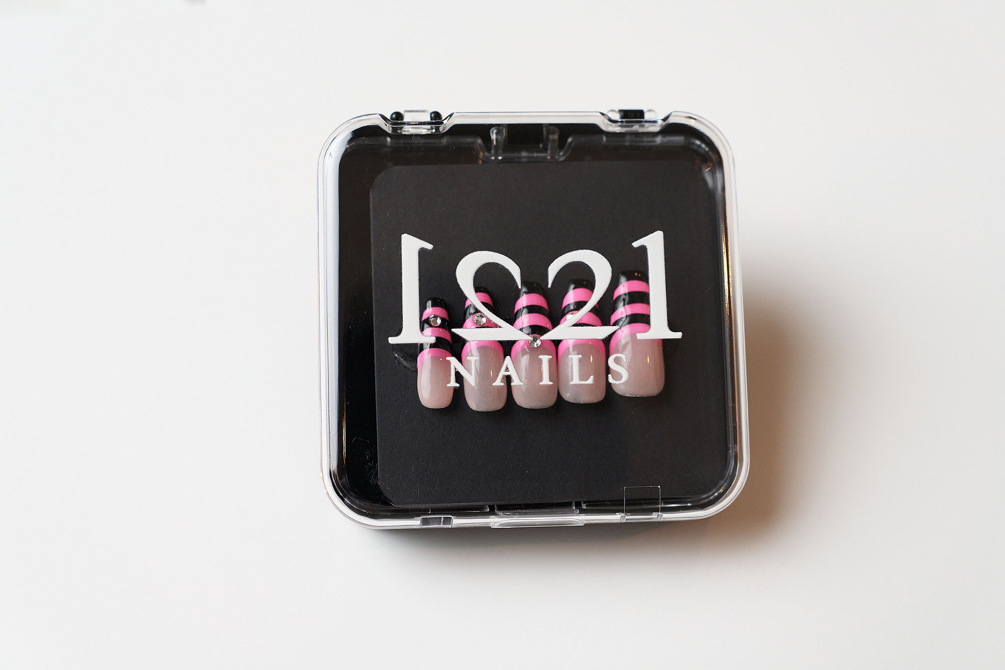 Black and Pink Stripes with Gems nails in their case